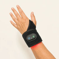 Wrist Bro red light wrist wrap worn on a raised hand