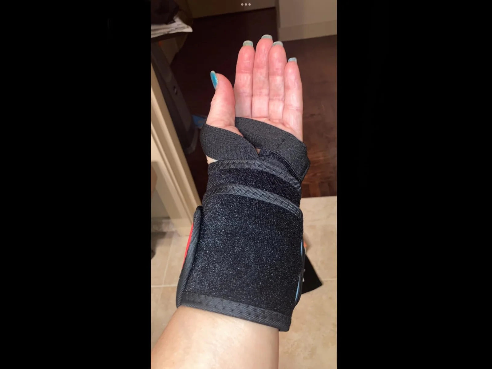 Customer wearing the black Wrist Bro wrap around the wrist and hand
